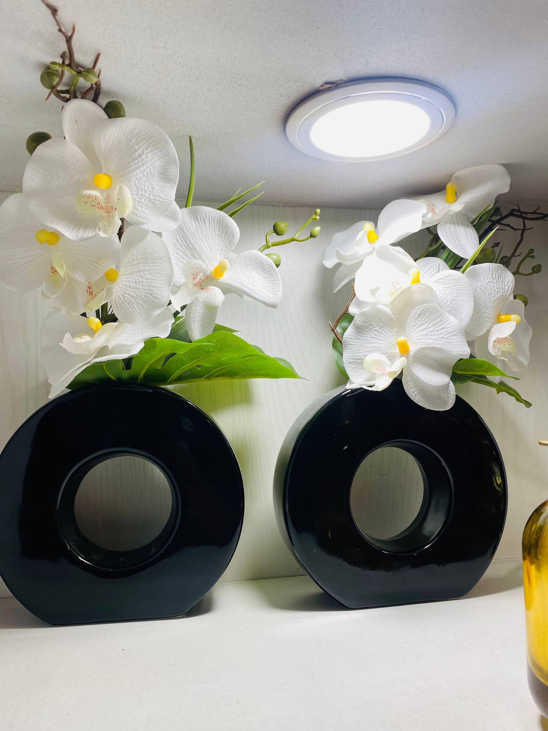 Black Ceramic Vase And Orchid Flowers
