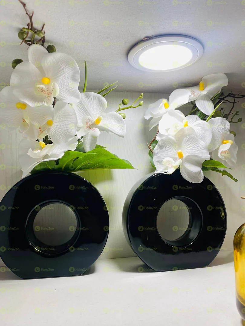 Black Ceramic Vase And Orchid Flowers